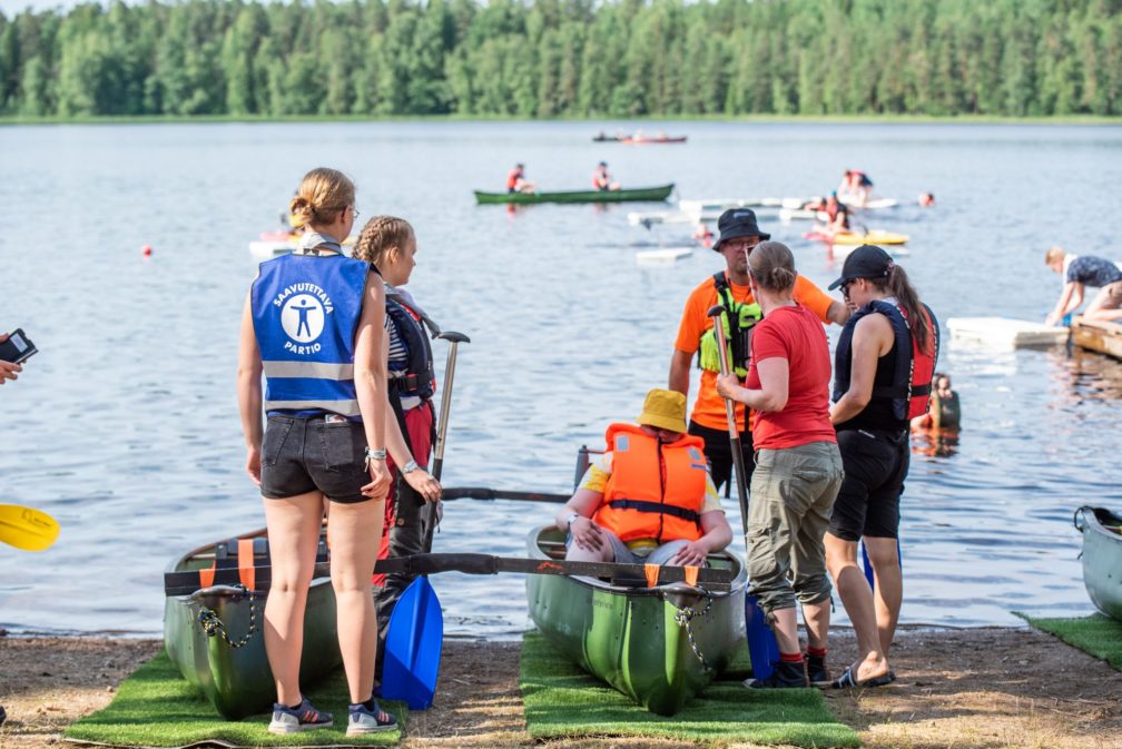 Group of people preparing for canoeing.